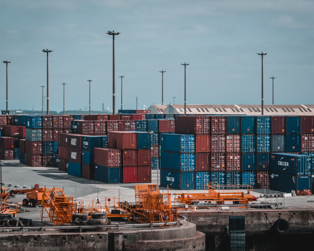 Container shipping yard with stacked cargo containers representing global supply chain and logistics operations