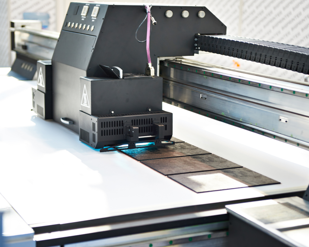 Industrial UV digital printer producing high-quality graphics on flat rigid substrates.